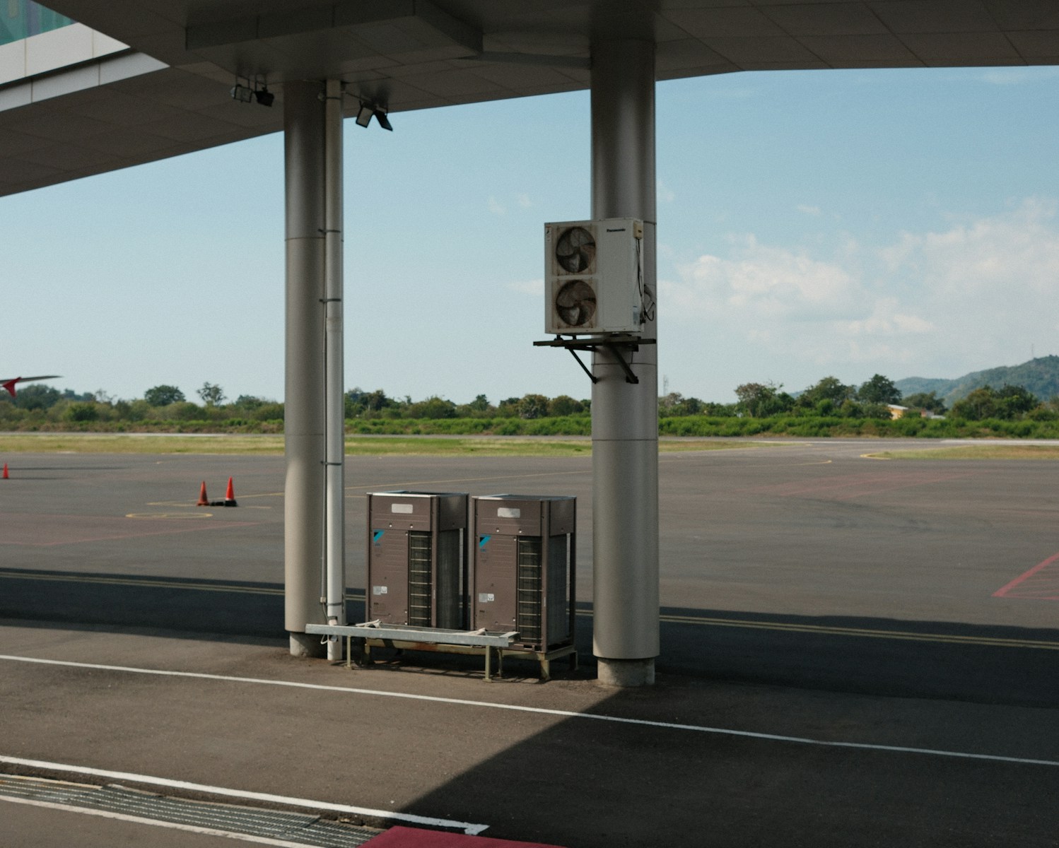 A gas station with a gas pump on the side of the road